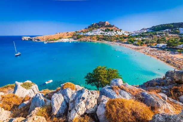 Rhodes, Greece. Lindos small whitewashed village and the Acropolis, scenery of Rhodos Island at Aegean Sea.