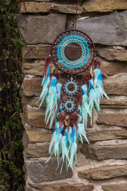 istock Handmade dream catcher with feathers threads and beads rope hanging 1055010632
