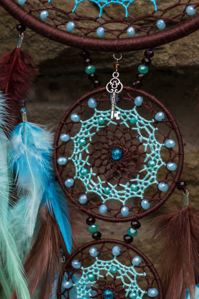 istock Handmade dream catcher with feathers threads and beads rope hanging 1055010654