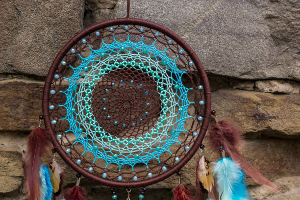 istock Handmade dream catcher with feathers threads and beads rope hanging 1055010664