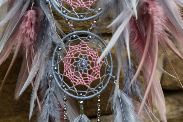 istock Handmade dream catcher with feathers threads and beads rope hanging 1055010892