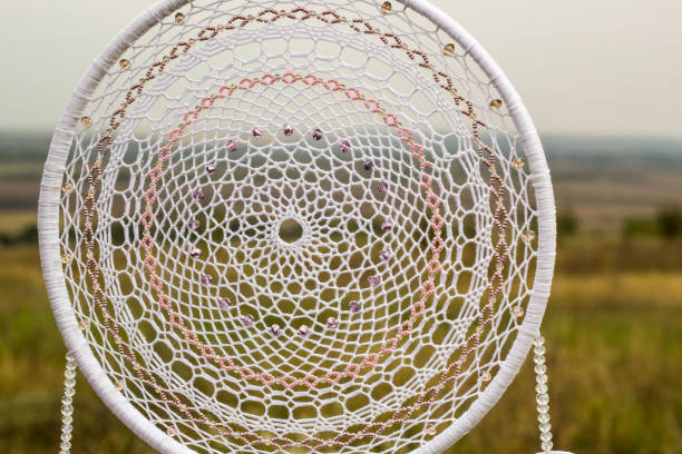 istock Handmade dream catcher with feathers threads and beads rope hanging 1055010902