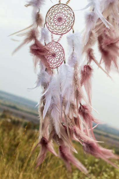 istock Handmade dream catcher with feathers threads and beads rope hanging 1055010906
