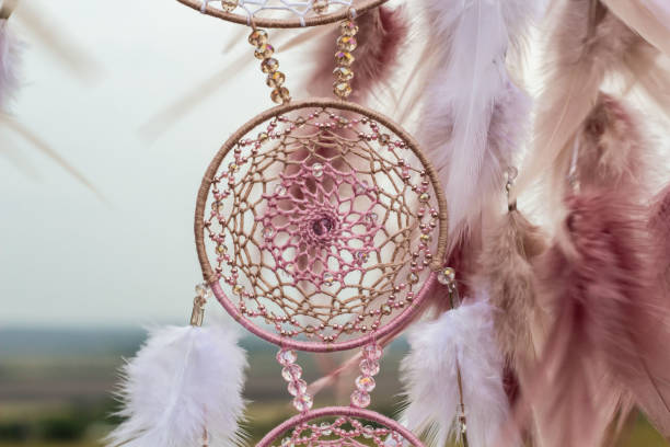 istock Handmade dream catcher with feathers threads and beads rope hanging 1055010942