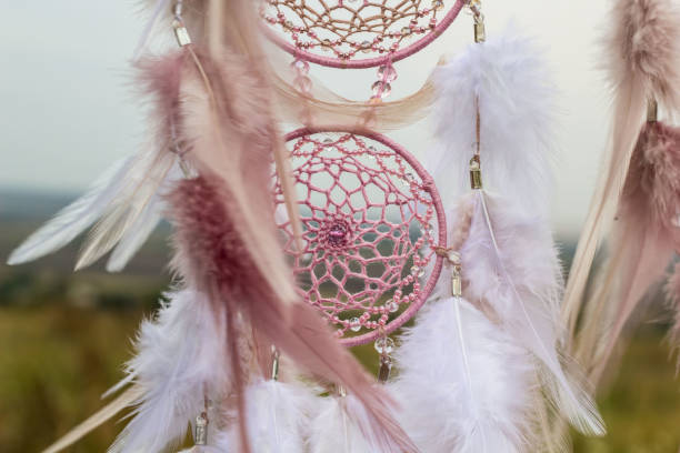 istock Handmade dream catcher with feathers threads and beads rope hanging 1055010994