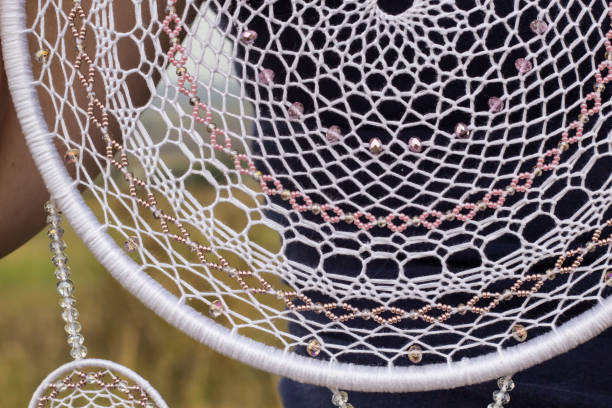 istock Handmade dream catcher with feathers threads and beads rope hanging 1055011006