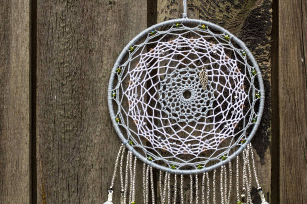 istock Handmade dream catcher with feathers threads and beads rope hanging 1055011104
