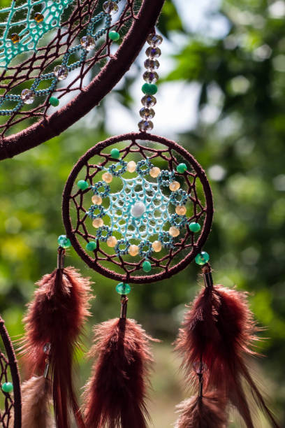 istock Handmade dream catcher with feathers threads and beads rope hanging 1055011346