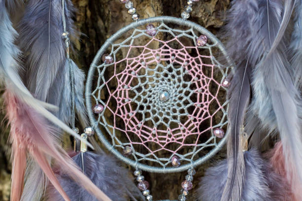 istock Handmade dream catcher with feathers threads and beads rope hanging 1055011456