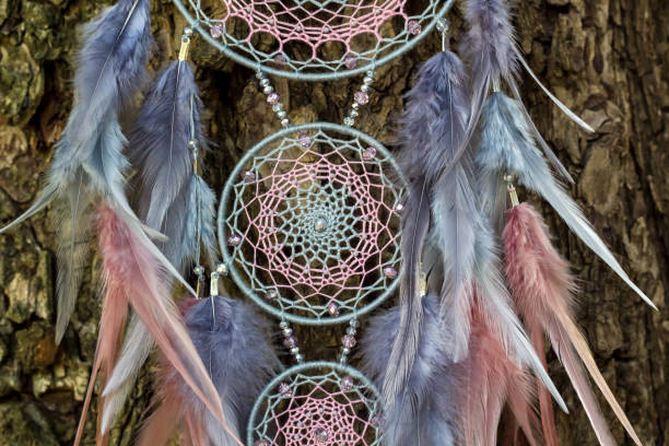 istock Handmade dream catcher with feathers threads and beads rope hanging 1055011500
