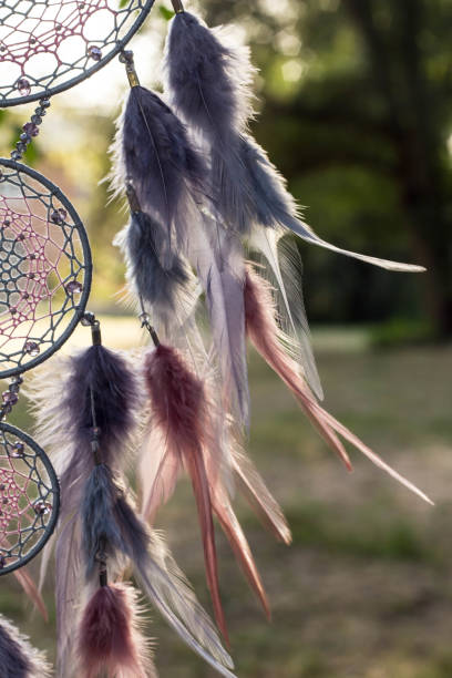 istock Handmade dream catcher with feathers threads and beads rope hanging 1055011526
