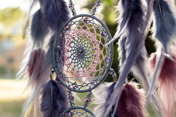 istock Handmade dream catcher with feathers threads and beads rope hanging 1055011586