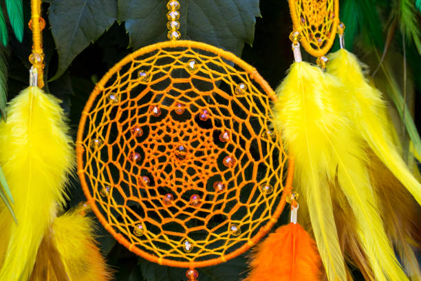 istock Handmade dream catcher with feathers threads and beads rope hanging 1055012836