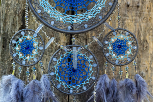 istock Handmade dream catcher with feathers threads and beads rope hanging 1055013418