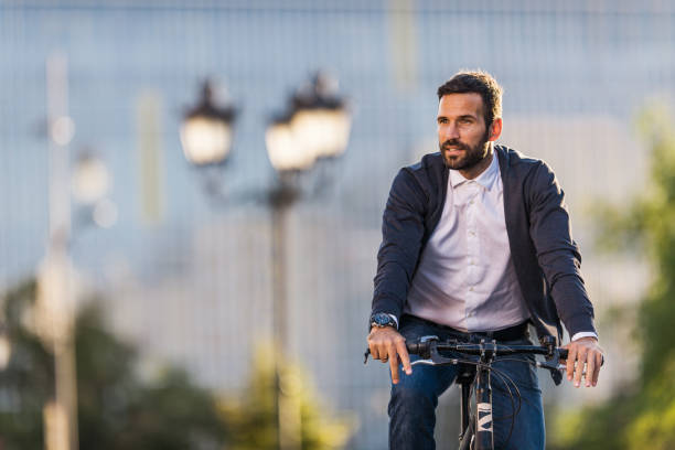 istock Young businessman going to work by bike. 1055013638