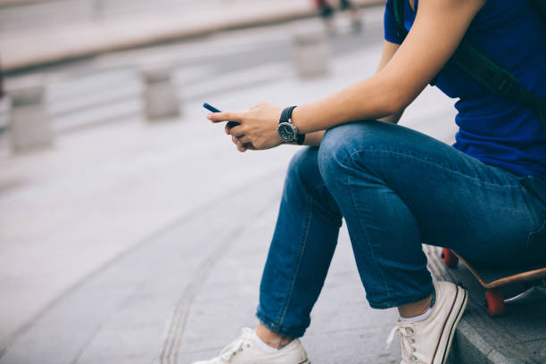 istock Woman hands using smartphone in modern city 1055014750