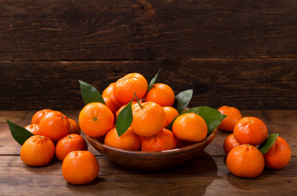 istock Fresh mandarin oranges fruit or tangerines with leaves in a bowl 1055015346