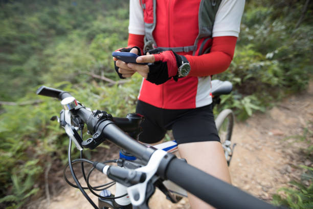 istock Using online application for searching GPS coordinates while riding bike in forest on sunny day 1055016676