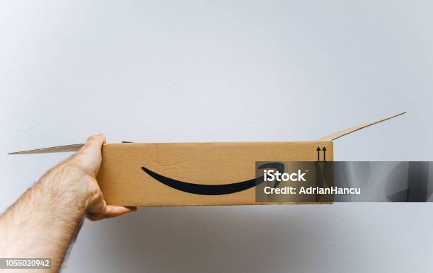 Amazon Cardboard Box Against White Background In Hand Stock Photo - Download Image Now