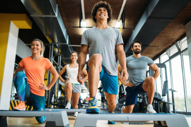 istock Group of young people doing exercises in gym 1055026596