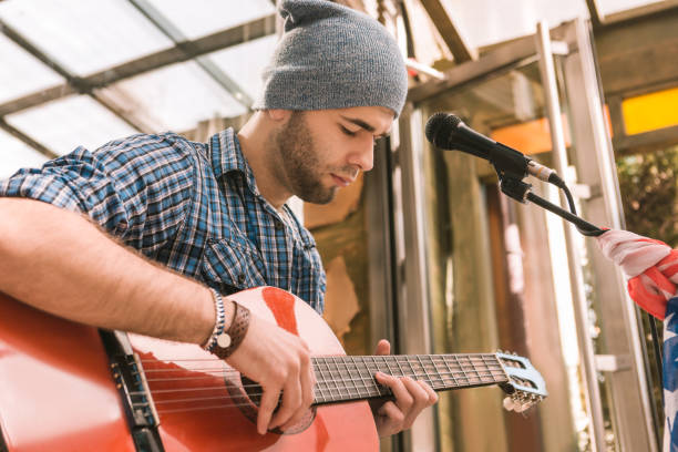 istock Focused male guitarist mastering his guitar technique 1055029020