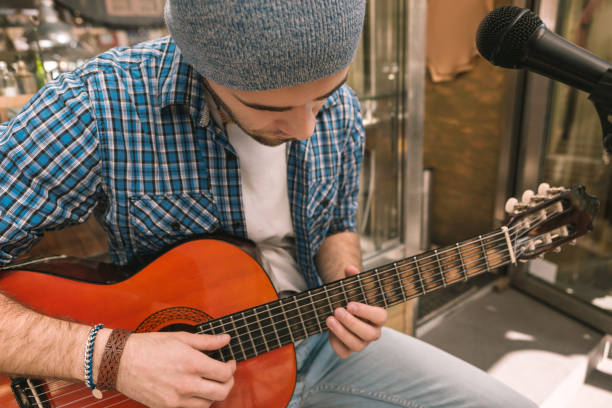istock Attentive male guitarist struggling for perfect technique 1055029032