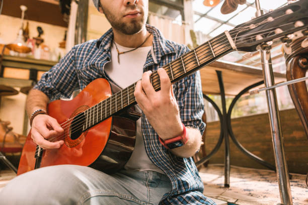 istock Young male guitarist acquiring knowledge for playing 1055029046