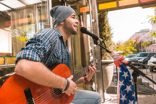 istock Serious male guitarist freeing emotions through singing 1055029082