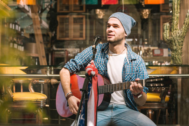 istock Creative male guitarist introducing song before singing 1055029174