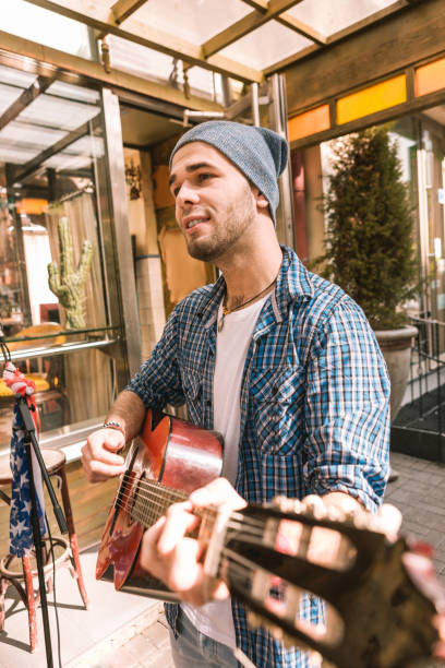 istock Reflective male guitarist experimenting with guitar play 1055029220