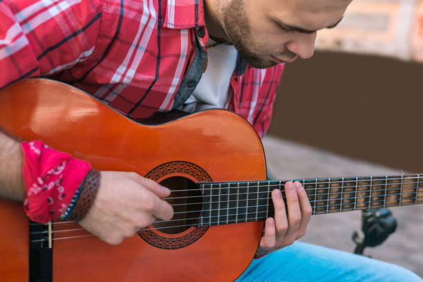 istock Serious street musician making guitar practice easier 1055030132