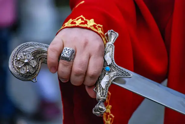 Photo of Hand holding traditional turkish sword