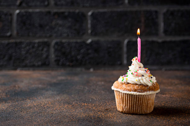 istock Birthday cupcake with cream and candle 1055035846