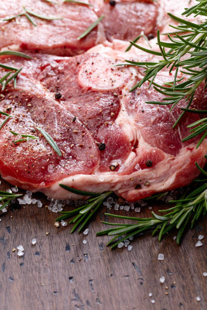 istock Raw pork with rosemary , salt and pepper. 1055037512