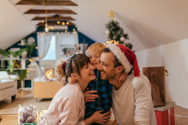 Christmas joy with my family Photo of a cute little family enjoying together the jolliest time of the year - Christmas family christmas stock pictures, royalty-free photos & images