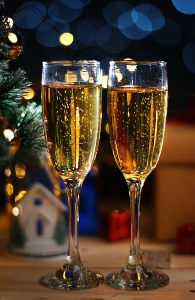 istock Two Glass Of Champagne Beside Christmas Tree 1055040858