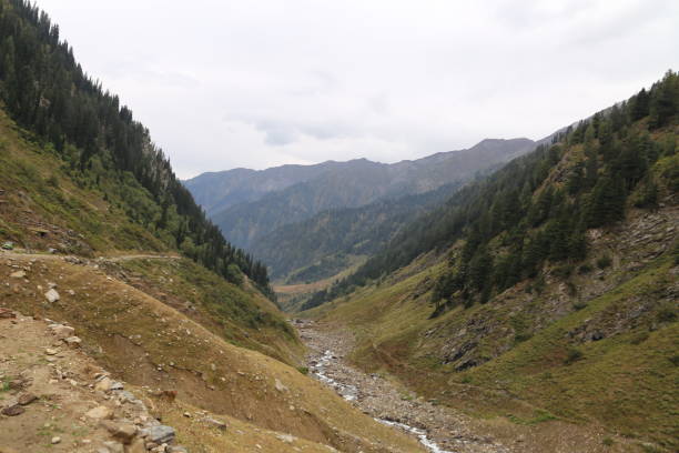 istock Small river passing through under the mountains under awesome weather 1055041142