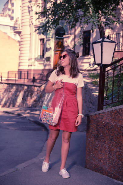 istock Dark-haired happy student heading to the university with her transparent bag 1055041226
