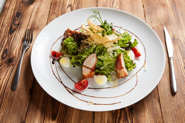 istock Chicken Salad. Chicken Caesar Salad. Caesar Salad with grilled chicken on plate. 1055044788