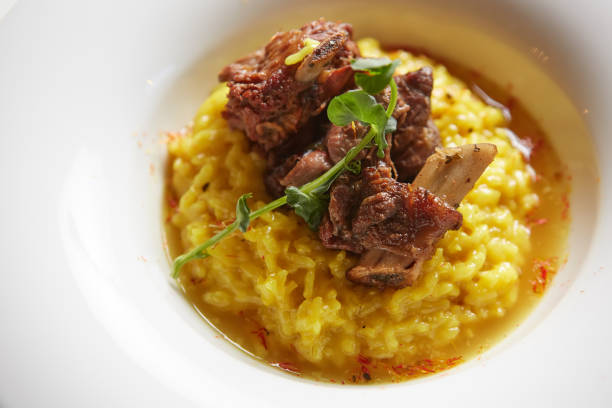 The ossobuco and saffron risotto. Shallow dof The ossobuco and saffron risotto. Shallow dof. ossobuco stock pictures, royalty-free photos & images