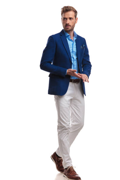 istock young smart casual man walking and rubbing hands 1055046076