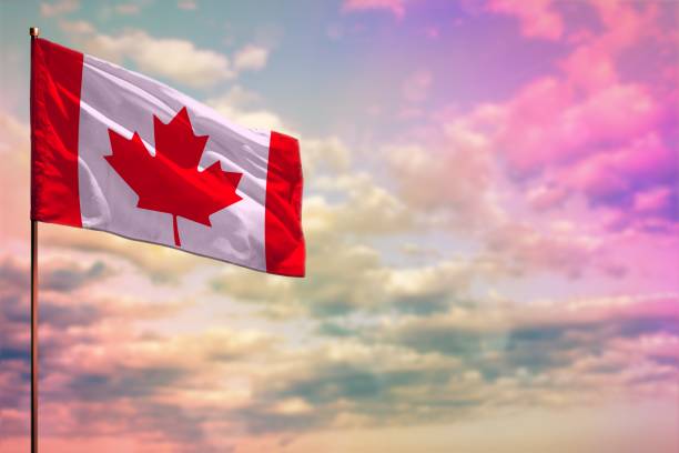 istock Fluttering Canada flag mockup with the space for your content on colorful cloudy sky background. 1055047230