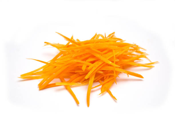 istock carrots cut into small slices on white background 1055047756