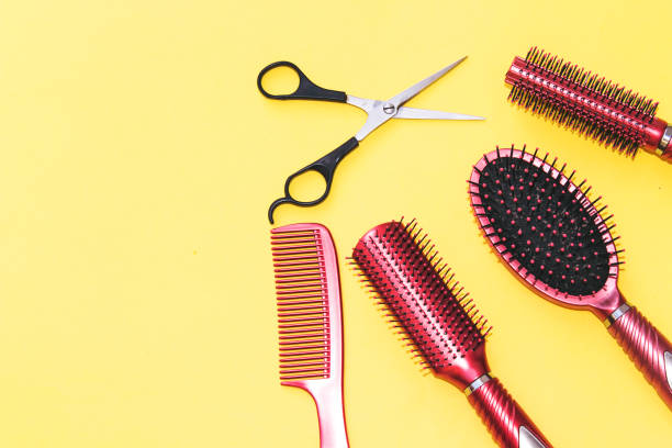 istock Professional hairdressing tools isolated on yellow background with copy space 1055047758