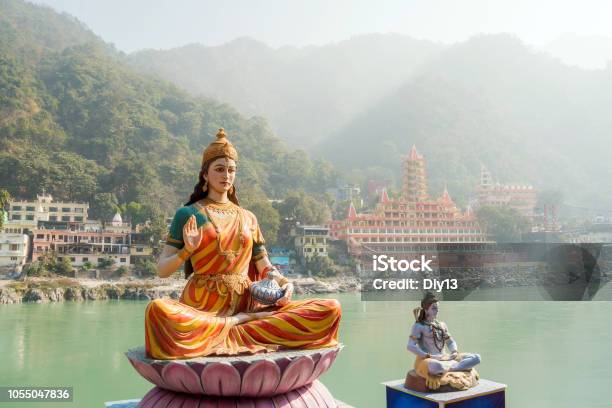 Statue Of Sitting Goddess Parvati And Statue Shiva On The Riverbank Of Ganga In Rishikesh Stock Photo - Download Image Now