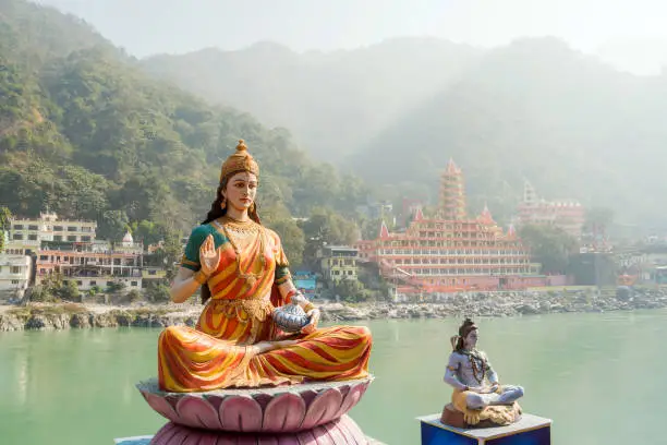 Statue of sitting goddess Parvati and Statue Shiva on the riverbank of Ganga in Rishikesh