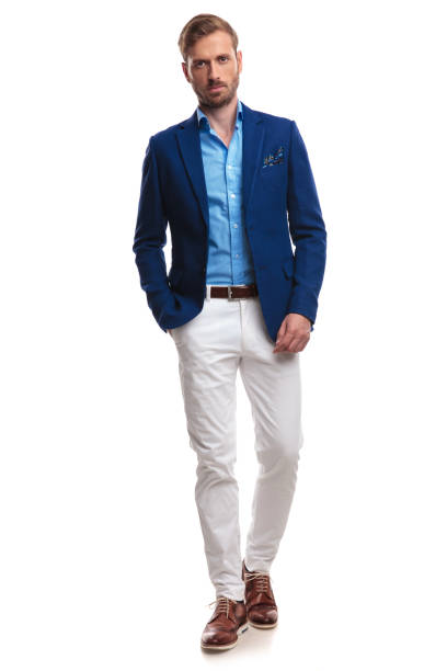 istock serious young elegant man standing with one hand in pocket 1055047858