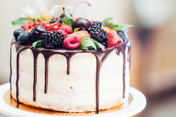 istock Wedding cake with strawberries, blackberries, blueberries, cherries on table 1055048698