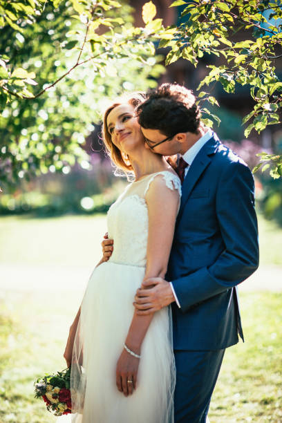 istock bride and groom on background summer forest 1055053448