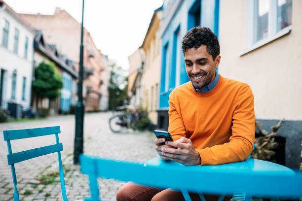 istock Gay man texting his partner and smiling 1055053736